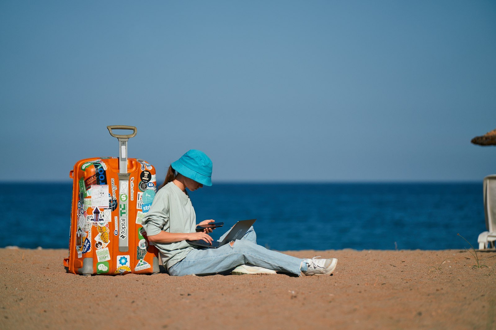 Woman working on a laptop with a sea view