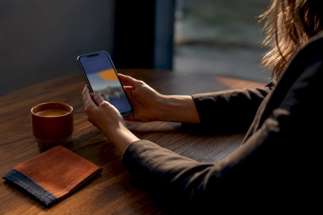 Advisor reviewing a travel guide on phone