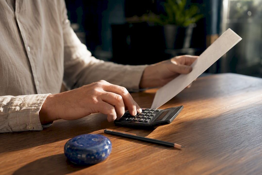 Hands calculating travel booking commission